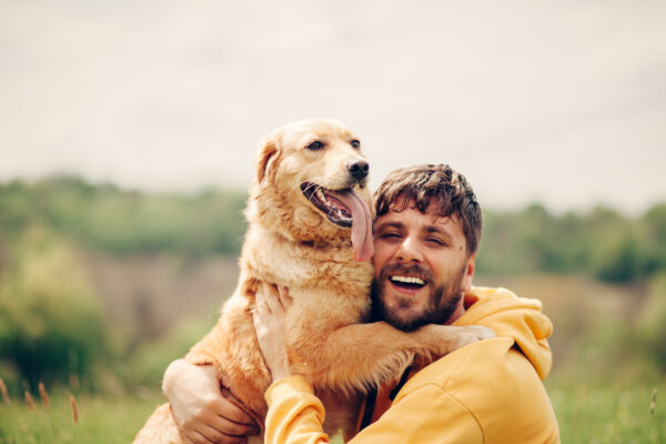 Guy and his dog, golden retriever, nature