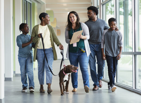 African-American family adopting dog from animal shelter