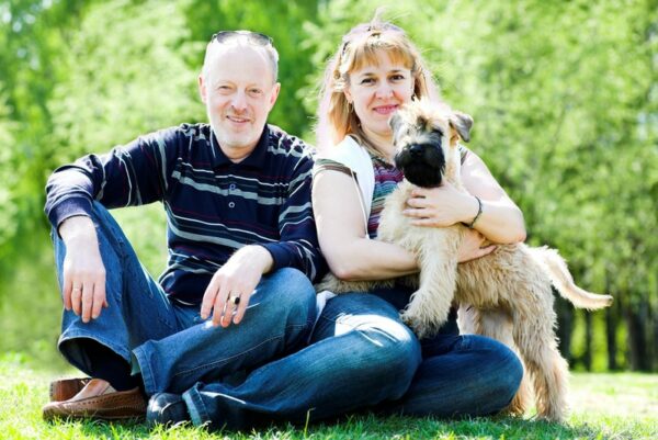 wheaten terier dog with his owner